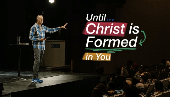 A man in a plaid shirt stands on a stage, speaking to an audience. Text overlay reads, 'Until... Christ is Formed in You'.
